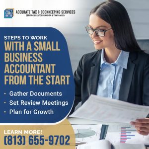 A smiling woman in glasses, dressed in business attire, reviews documents, illustrating the process of working with a small business accountant.
